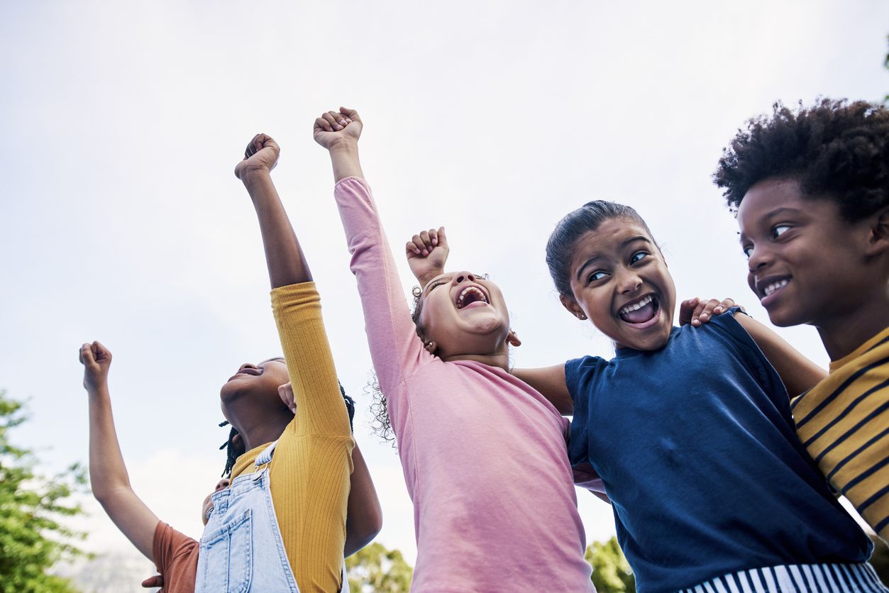 Smiling kids celebrating after winning games at a family-friendly event