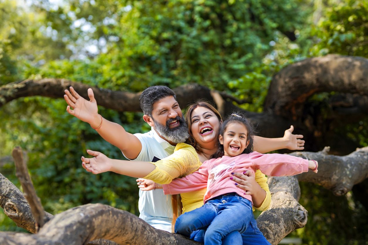 Family enjoying a day at the zoo with kids exploring animal exhibits